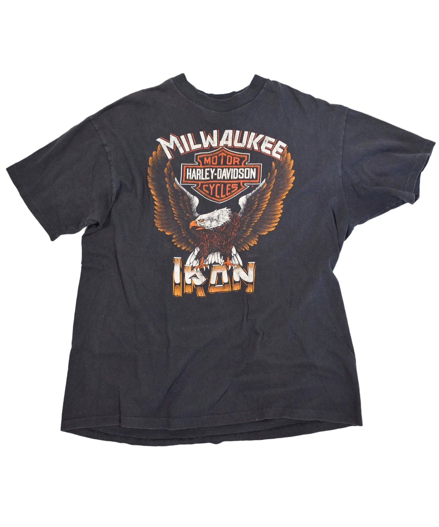 A black short-sleeve t-shirt featuring a large graphic print of an eagle and the Harley-Davidson logo, with 'MILWAUKEE' and 'IRON' text, displayed on a white background.
