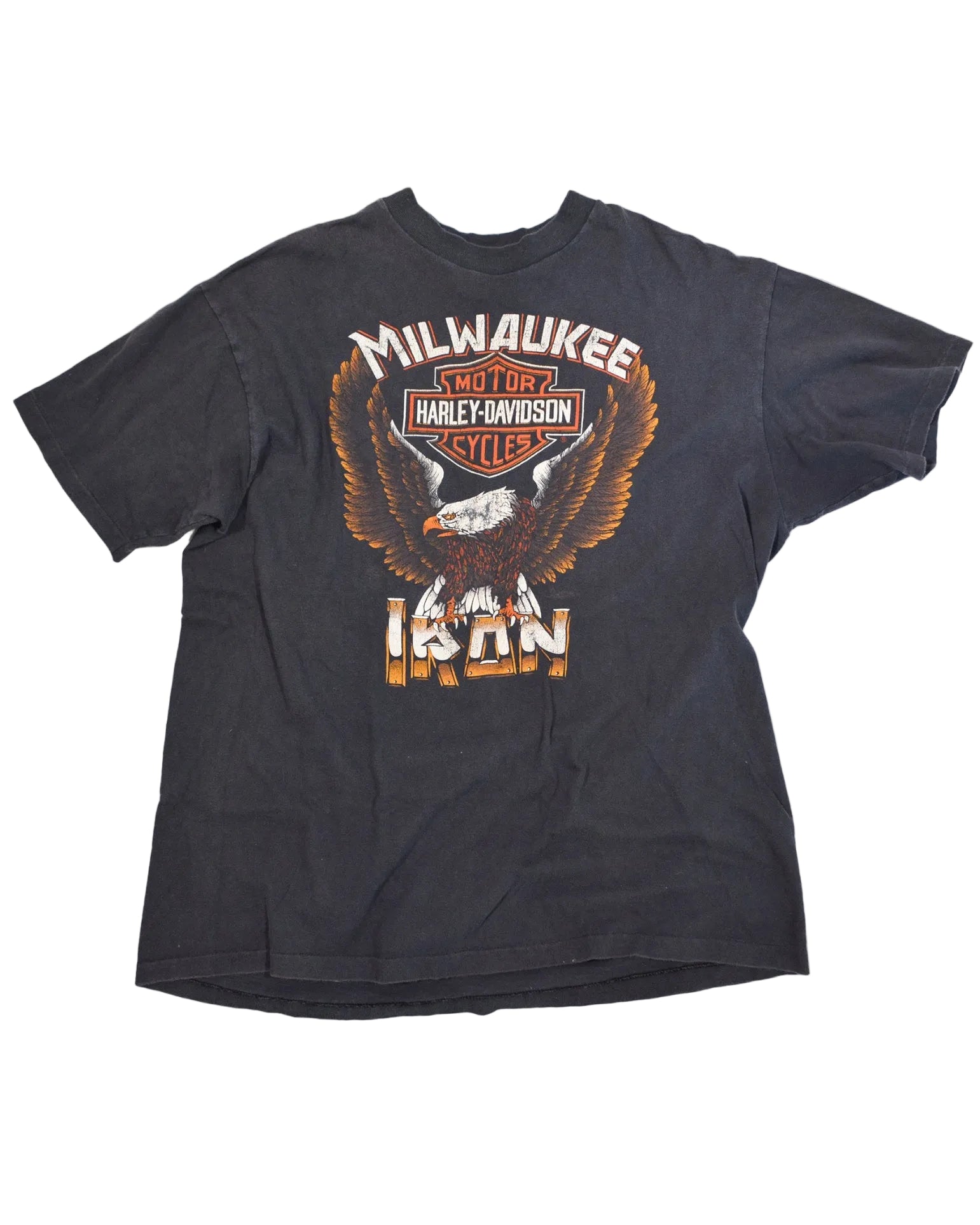 A black short-sleeve t-shirt featuring a large graphic print of an eagle and the Harley-Davidson logo, with 'MILWAUKEE' and 'IRON' text, displayed on a white background.
