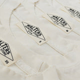 Three folded off-white cotton t-shirts stacked diagonally, showing the collar and printed 'Walters' brand labels.